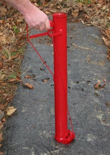 poke handheld planter into soil